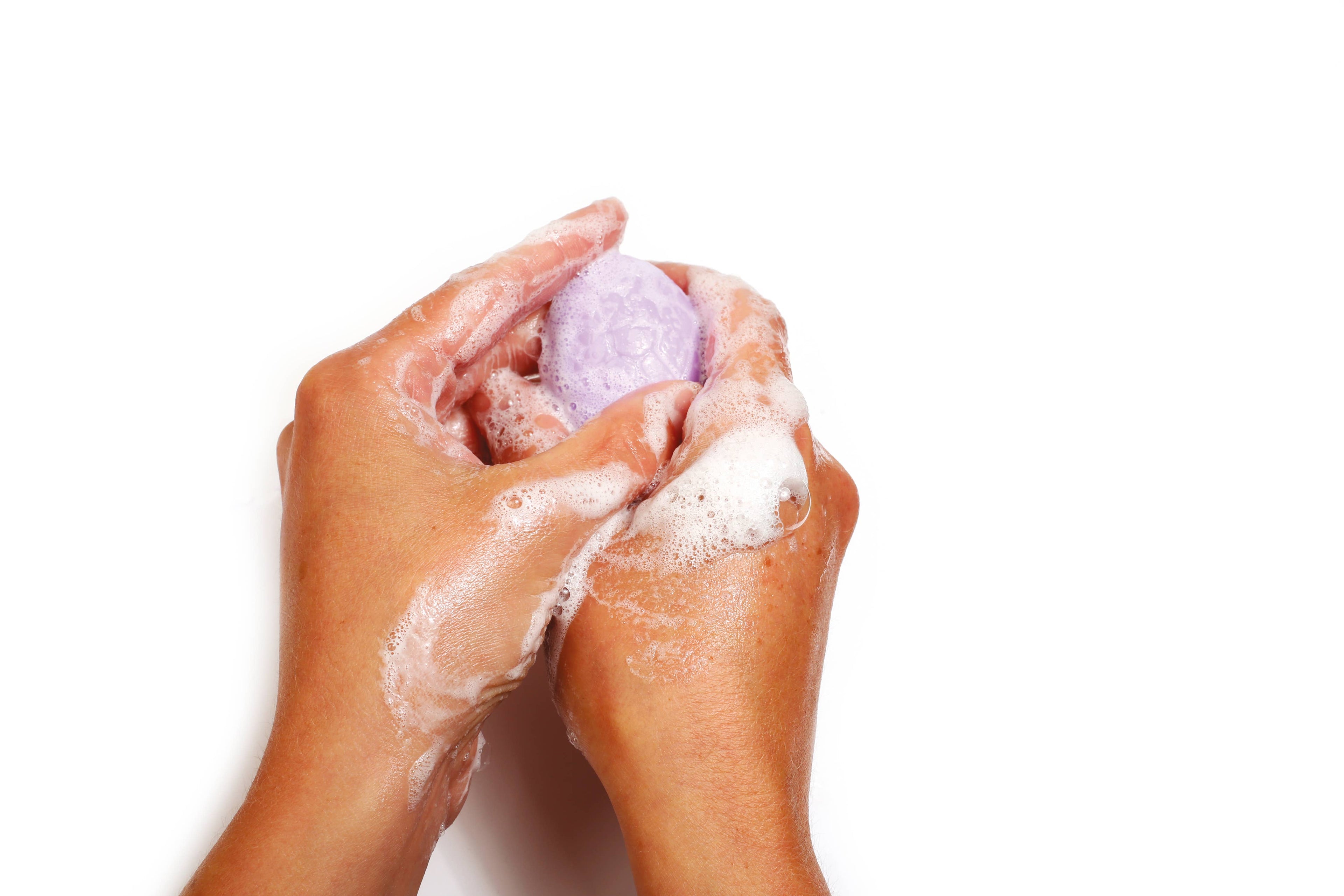 Child washing hands with dinosaur soap