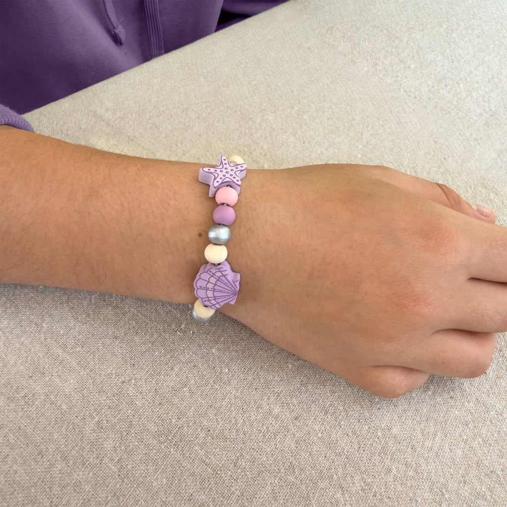 Child wearing handmade seashell bracelet