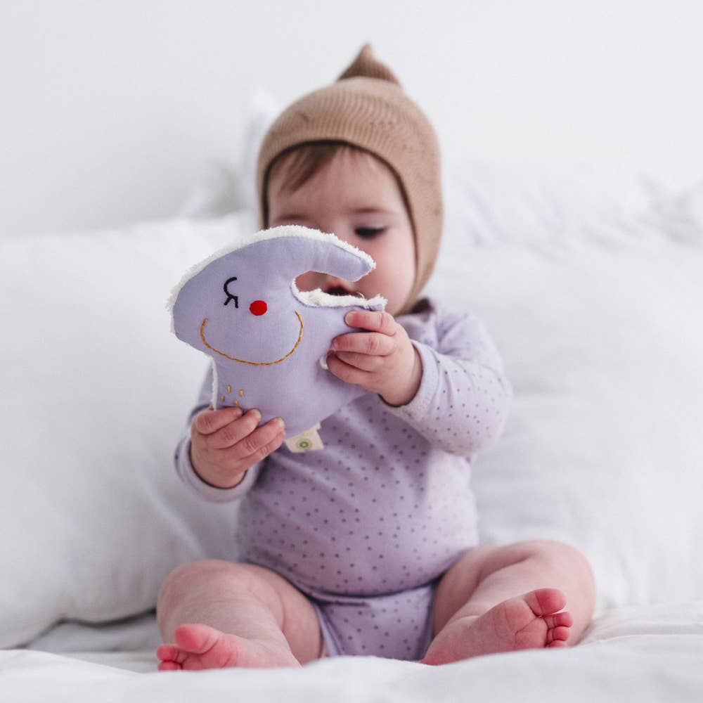 Baby teething on organic cotton elephant rattle