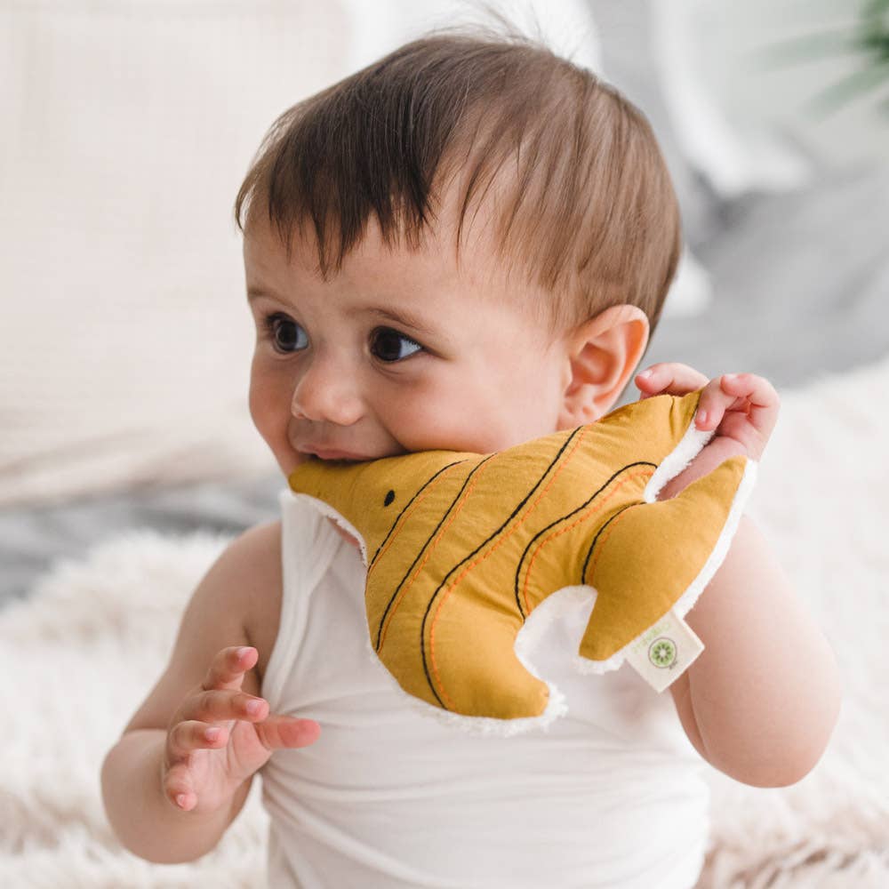 Baby holding organic cotton fish rattle