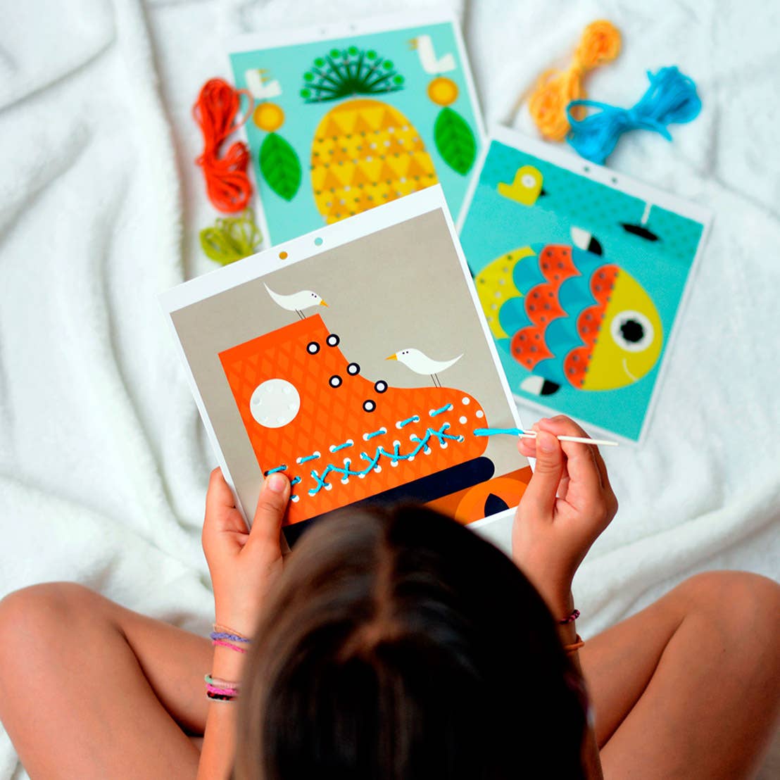 Child using kids embroidery kit for beginners