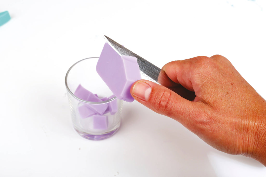 Shaping soap in dinosaur soap making kit
