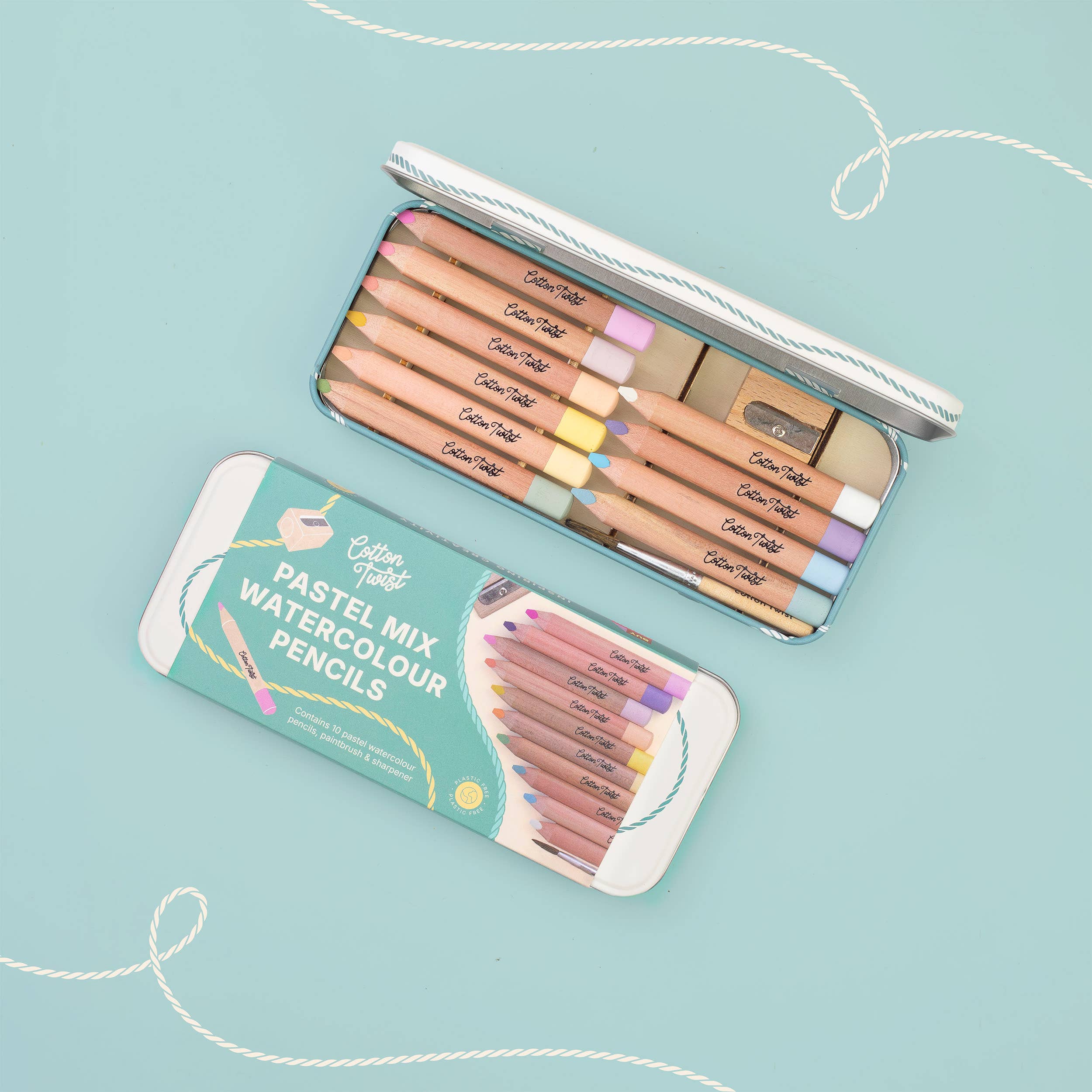 Watercolour pencils set flat lay on teal background
